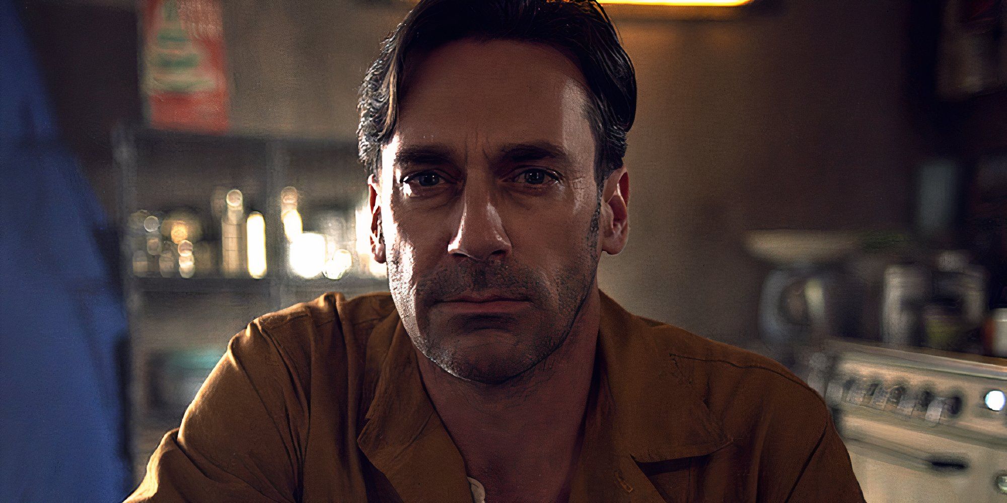 Jon Hamm as Matt Trent in Black Mirror's White Christmas, looking at the camera with a serious expression.