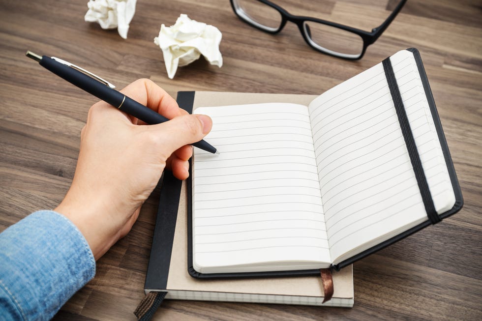 Woman hand writing on notebook