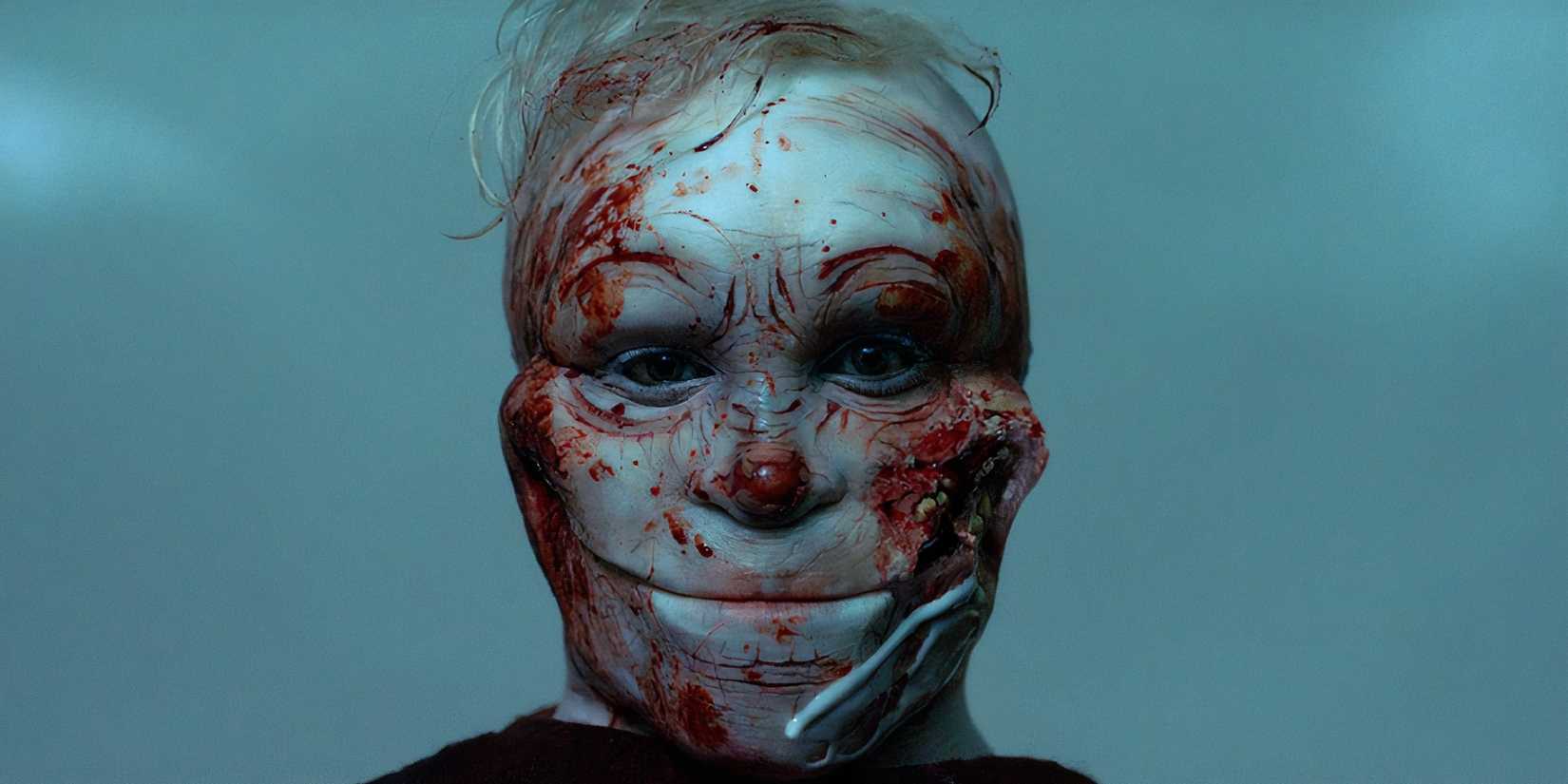 A bloodied Pretzel Jack, the creature from Channel Zero: The Dream Door, smiling at the camera